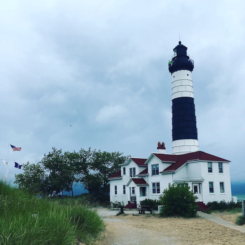 lighthouse on the shores of lake michigan on a stormy day