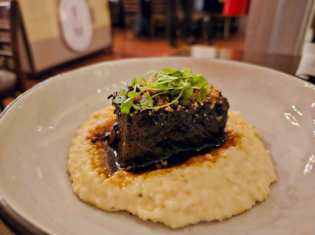 Cheerwine-braised short ribs with grits and flecks of peanut brittle from Fort Mill's FM Eatery during a visit to ChristmasVille.